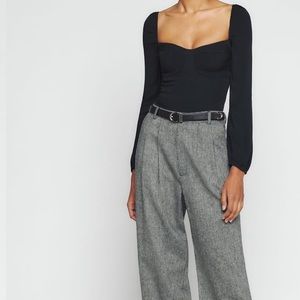 Black reformation long sleeve blouse. The top is slim fitting through the bodice